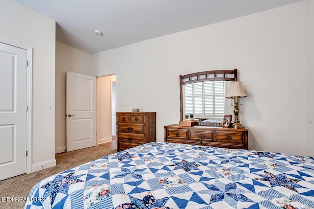 bedroom with carpet and baseboards