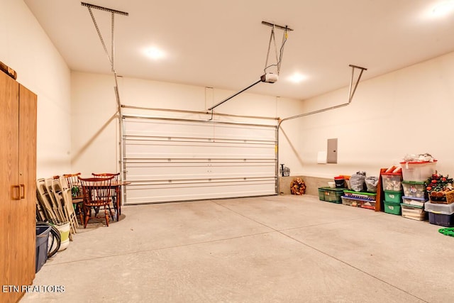 garage featuring electric panel and a garage door opener