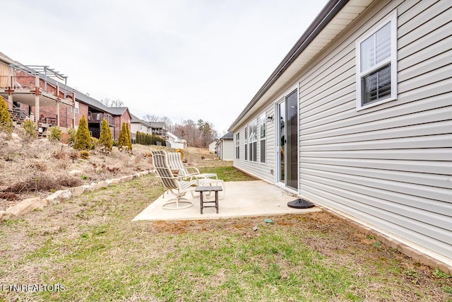 view of yard featuring a residential view and a patio