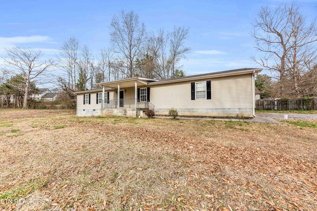 view of front of property featuring fence, covered porch, and crawl space