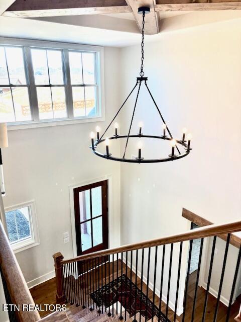 stairway featuring wood finished floors and baseboards