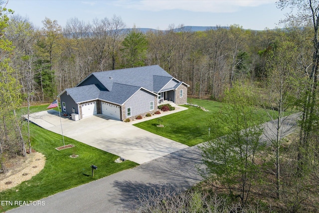birds eye view of property with a forest view