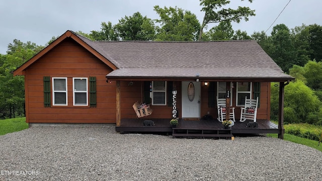 view of front of property featuring a porch and roof with shingles