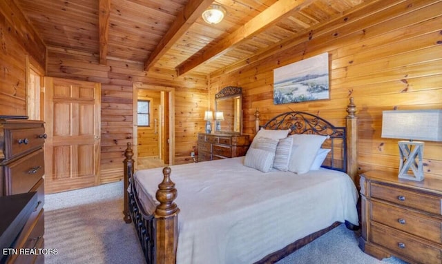 bedroom with beamed ceiling, wooden walls, wood ceiling, and carpet flooring