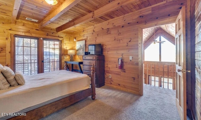 carpeted bedroom with beam ceiling, wood walls, and wood ceiling