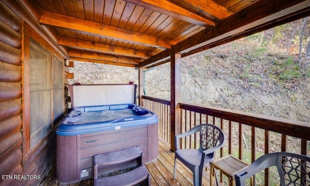 wooden terrace featuring a hot tub