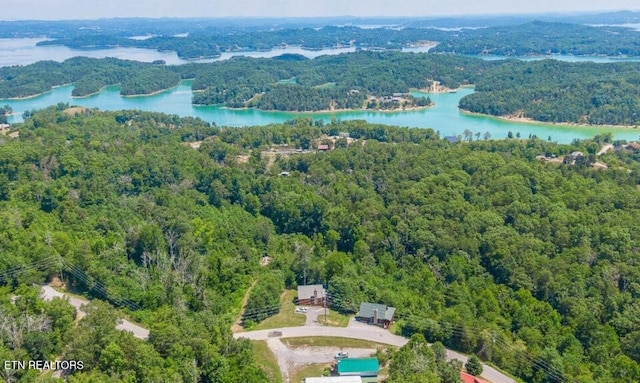 aerial view featuring a forest view and a water view