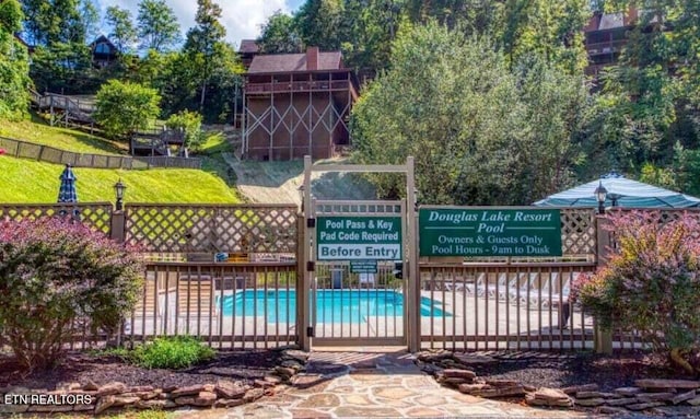 exterior space featuring fence and a fenced in pool