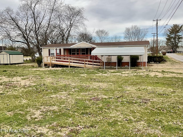 rear view of house with a storage unit, a deck, a lawn, and an outdoor structure