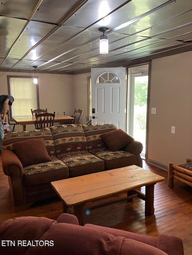 living room featuring baseboards and wood finished floors