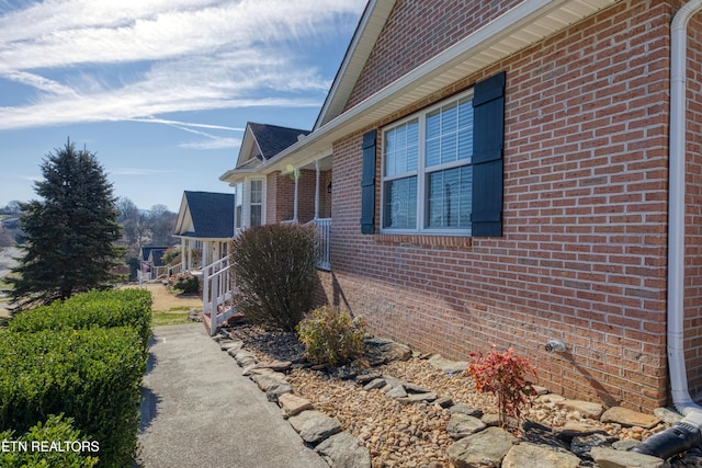 view of property exterior with brick siding