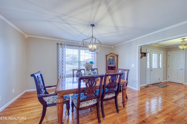 dining room with a wealth of natural light, a notable chandelier, light wood-style floors, and a textured ceiling