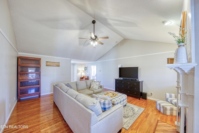 living area featuring lofted ceiling, wood finished floors, baseboards, and ceiling fan