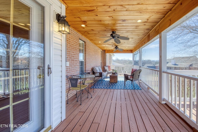 wooden terrace featuring a ceiling fan