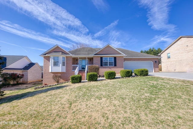 single story home with a front lawn, an attached garage, brick siding, and driveway