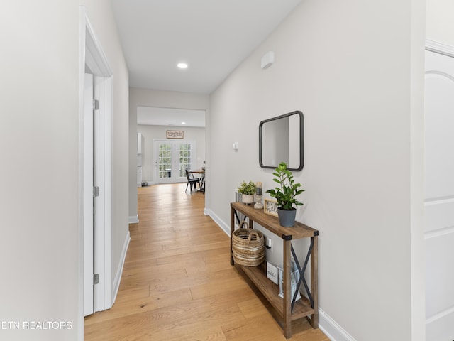 hallway featuring recessed lighting, baseboards, and light wood-style floors