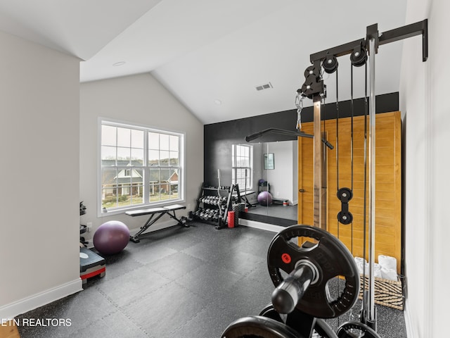 workout area featuring visible vents, baseboards, and lofted ceiling