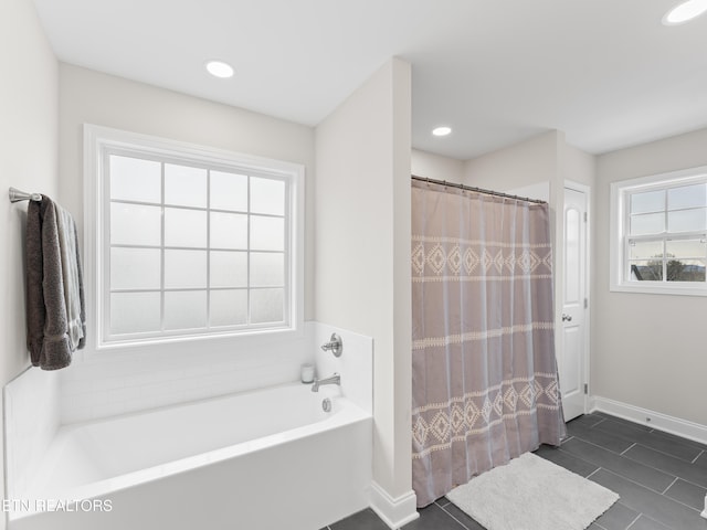 bathroom featuring tile patterned flooring, curtained shower, baseboards, a tub to relax in, and recessed lighting