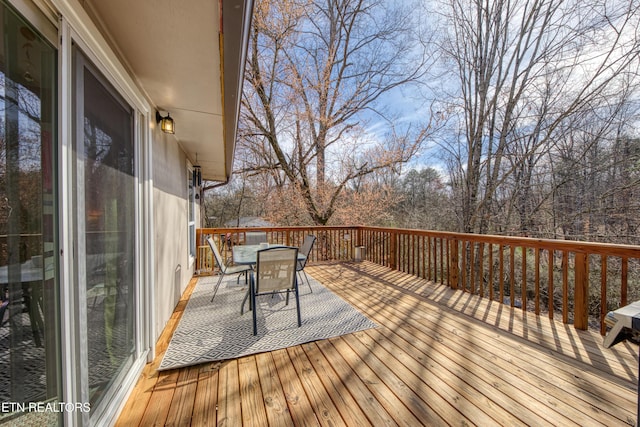 wooden terrace featuring outdoor dining space