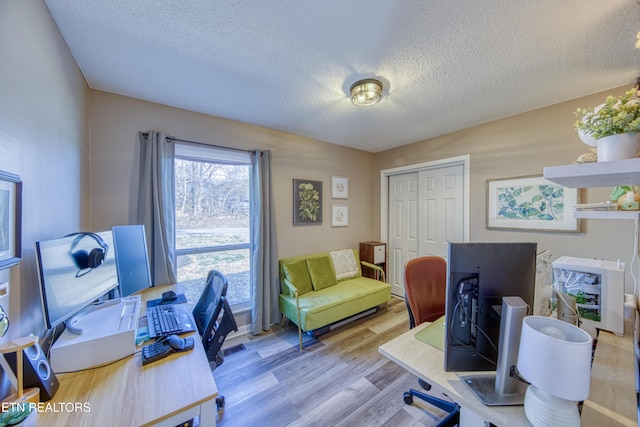 office area with a textured ceiling and wood finished floors