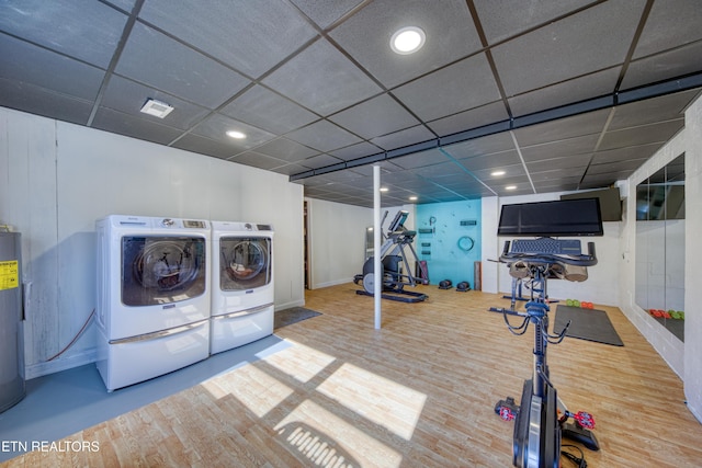 laundry area featuring water heater, laundry area, recessed lighting, wood finished floors, and washer and dryer