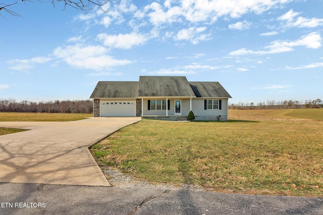 view of front facade with stone siding, an attached garage, concrete driveway, and a front yard