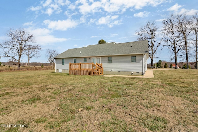 rear view of property featuring crawl space, a wooden deck, a yard, and roof with shingles