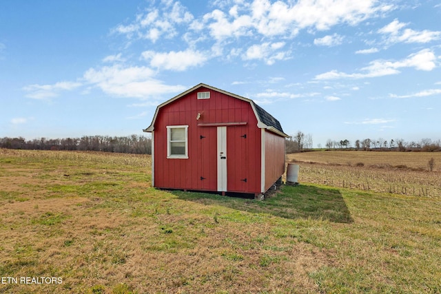 view of outdoor structure featuring a rural view and an outdoor structure