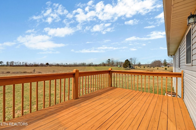 wooden deck with a yard and a rural view