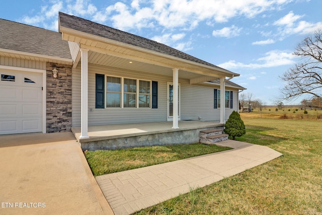 view of front of property with an attached garage, covered porch, a shingled roof, a front lawn, and stone siding