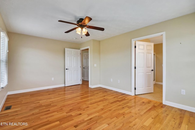 unfurnished bedroom with visible vents, baseboards, light wood-style floors, and a ceiling fan