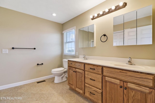 full bathroom with tile patterned floors, toilet, baseboards, and a sink