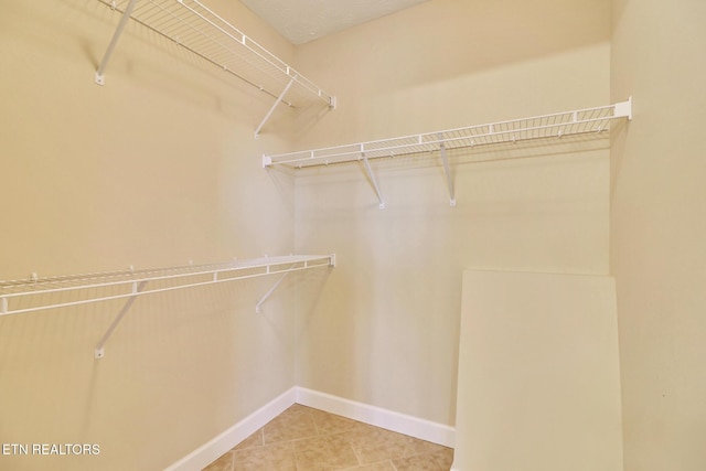 spacious closet featuring tile patterned floors