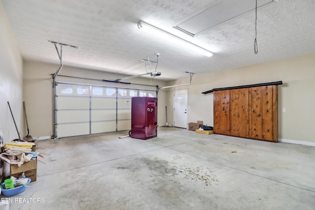 garage featuring baseboards and a garage door opener