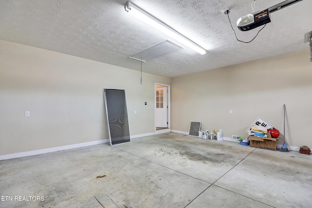 garage with a garage door opener and baseboards