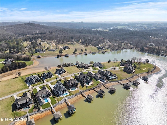 birds eye view of property with a water view and a residential view