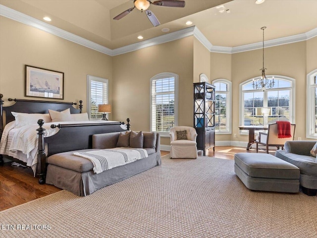 bedroom featuring recessed lighting, wood finished floors, a high ceiling, and ornamental molding