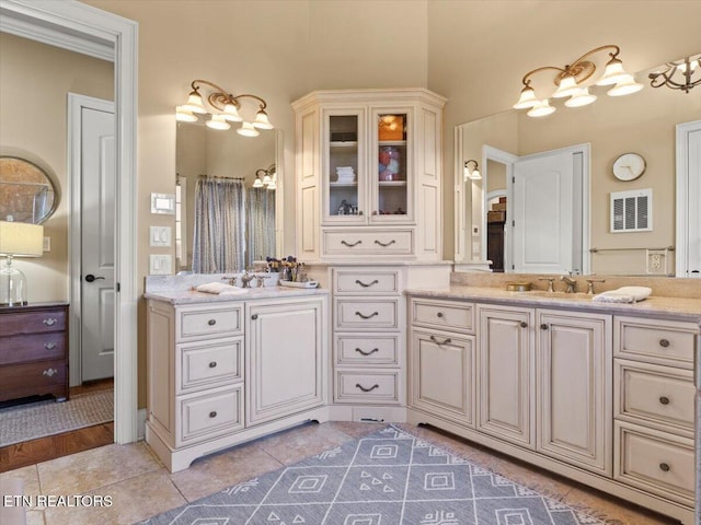 bathroom featuring tile patterned floors, visible vents, and vanity