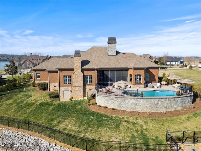 back of property featuring a patio, a yard, a sunroom, a chimney, and fence private yard