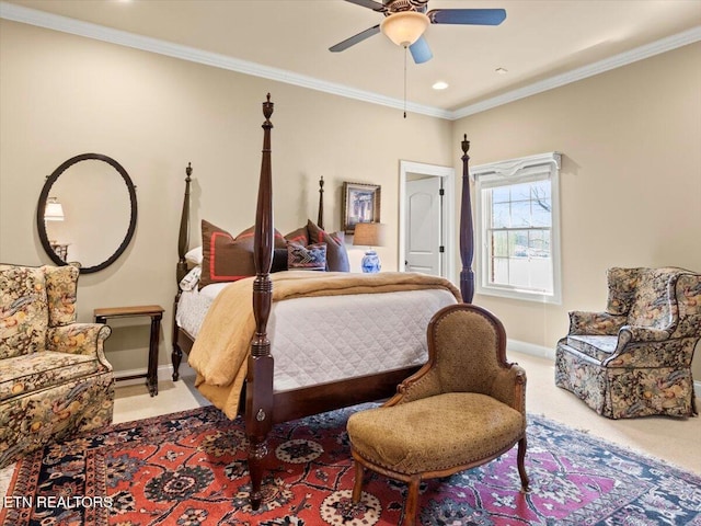 carpeted bedroom with ceiling fan, crown molding, and baseboards