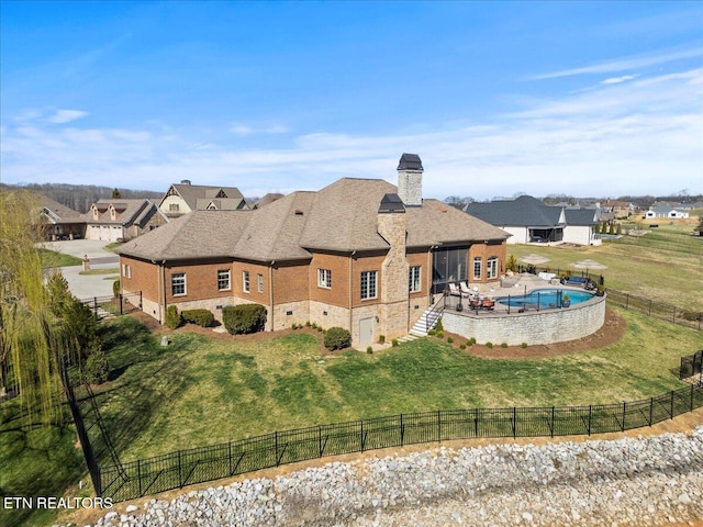 back of house featuring a patio, a lawn, and a fenced backyard