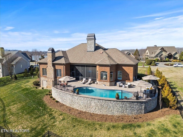 view of pool with a patio, a yard, and fence