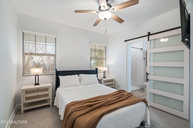 carpeted bedroom featuring ceiling fan, baseboards, and a barn door