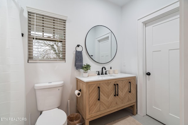 bathroom featuring toilet and vanity