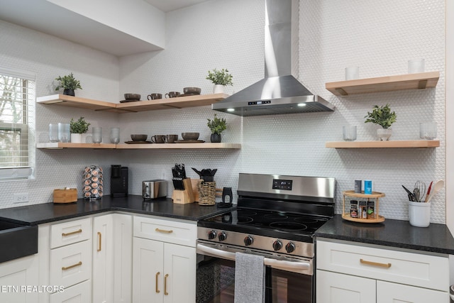 kitchen with white cabinetry, open shelves, wall chimney range hood, and stainless steel electric stove