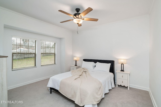 bedroom featuring baseboards, light colored carpet, ornamental molding, and a ceiling fan