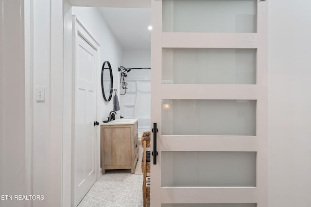 full bath featuring vanity and a shower