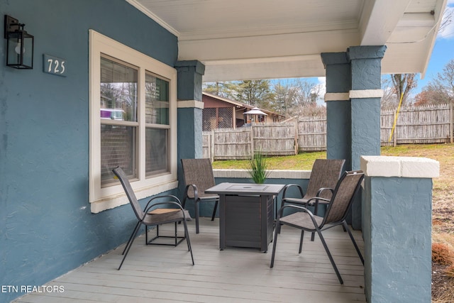 wooden terrace featuring fence