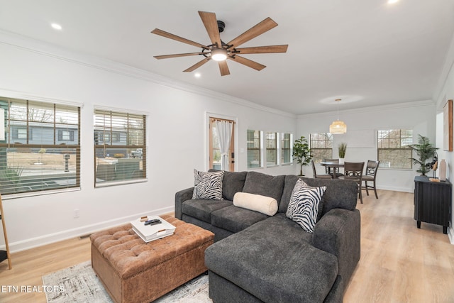 living area featuring recessed lighting, light wood-type flooring, baseboards, and crown molding