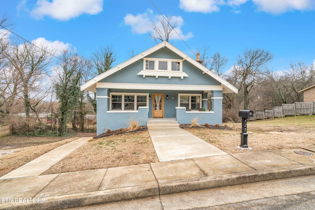 bungalow-style house with a porch and stucco siding